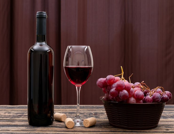 Wine bottle, glass, and grapes